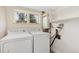 Laundry room with washer, dryer, shelving, and window at 80 S 38Th St, Boulder, CO 80305