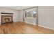 Cozy living room with hardwood floors, a brick fireplace, and a large window at 80 S 38Th St, Boulder, CO 80305