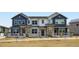 New two-story townhomes boast stone accents, inviting entryways, and professionally landscaped yards at 6579 Parterre N Pkwy # 2, Thornton, CO 80602