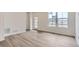 Bright and airy living room showcasing hardwood floors and ample natural light at 6579 Parterre N Pkwy # 2, Thornton, CO 80602