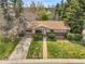 Charming home with well-manicured lawn, mature trees, and driveway leading to attached garage at 6832 S Birch Way, Centennial, CO 80122