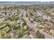 Expansive aerial view of a suburban neighborhood with tree-lined streets and mountain views in the distance at 6832 S Birch Way, Centennial, CO 80122