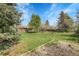 Expansive backyard with lush lawn, mature trees, and well-maintained landscaping at 6832 S Birch Way, Centennial, CO 80122