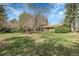 Expansive backyard featuring lush lawn and mature trees, perfect for outdoor activities at 6832 S Birch Way, Centennial, CO 80122