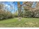 Well-maintained backyard with green lawn and mature trees, creating a serene outdoor space at 6832 S Birch Way, Centennial, CO 80122