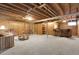 Finished basement with carpeted floor, exposed ceiling, wood paneled wall, and bar area at 6832 S Birch Way, Centennial, CO 80122