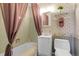Compact bathroom featuring a tub with shower, a vanity, and pink accents at 6832 S Birch Way, Centennial, CO 80122