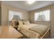 Bright bedroom with floral wallpaper, curtains, and neutral-colored bedding and side table at 6832 S Birch Way, Centennial, CO 80122