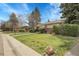 Well-maintained lawn and landscaping with mature trees complement this charming ranch-style home at 6832 S Birch Way, Centennial, CO 80122