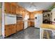 A functional kitchen with wood cabinets, brick backsplash, and modern appliances at 6832 S Birch Way, Centennial, CO 80122