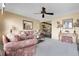 A cozy living room features neutral walls, plush carpeting, and a ceiling fan at 6832 S Birch Way, Centennial, CO 80122