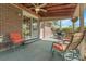 Covered brick patio with outdoor seating, ceiling fan, and view of the backyard at 6832 S Birch Way, Centennial, CO 80122