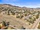 Expansive aerial view of the neighborhood nestled near the mountains and mature trees in scenic Colorado at 4 Prairie Falcon Ln, Littleton, CO 80127