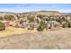 An aerial view of a home surrounded by mature trees and rolling hills at 4 Prairie Falcon Ln, Littleton, CO 80127