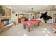 Finished basement featuring a pool table, stone fireplace, and an open layout at 4 Prairie Falcon Ln, Littleton, CO 80127