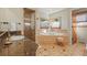 Bright bathroom featuring a walk-in shower, soaking tub with tile surround, and granite countertops at 4 Prairie Falcon Ln, Littleton, CO 80127