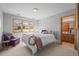 Cozy bedroom featuring a decorative wreath on the bed and a window with mountain views at 4 Prairie Falcon Ln, Littleton, CO 80127