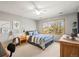 Well-lit bedroom featuring a ceiling fan, large window, wood furniture and tasteful decor at 4 Prairie Falcon Ln, Littleton, CO 80127