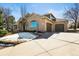 Spacious driveway leading to a three-car garage, complemented by a well-maintained yard at 4 Prairie Falcon Ln, Littleton, CO 80127