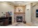 Close up view of the basement fireplace with stone surround, a mantel, and decorative accents at 4 Prairie Falcon Ln, Littleton, CO 80127