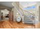 Elegant foyer featuring a curved staircase, hardwood floors, and abundant natural light at 4 Prairie Falcon Ln, Littleton, CO 80127