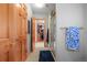 Hallway features multiple rooms, a shower with glass doors, wood doors, and linen storage at 4 Prairie Falcon Ln, Littleton, CO 80127