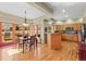 An eat-in kitchen and dining area with hardwood floors, wooden cabinets, and views through french doors and windows at 4 Prairie Falcon Ln, Littleton, CO 80127