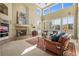 Cozy living room with a fireplace, large windows, and comfortable seating at 4 Prairie Falcon Ln, Littleton, CO 80127