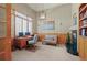 Bright home office with a large window, custom shelving, and a cozy fireplace at 4 Prairie Falcon Ln, Littleton, CO 80127