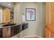 Powder room with a floating black marble vanity and hardwood floors at 4 Prairie Falcon Ln, Littleton, CO 80127