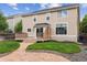 Back exterior of house features a deck, landscaped yard, and stone walkway at 4016 S Rome St, Aurora, CO 80018