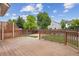 Well-maintained backyard deck with wooden railing and lattice detail overlooking the landscaped backyard at 4016 S Rome St, Aurora, CO 80018