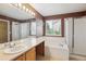 Bathroom showcasing soaking tub, walk-in shower, and vanity with ample counter space at 4016 S Rome St, Aurora, CO 80018