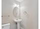 Half bath featuring white pedestal sink and toilet at 4016 S Rome St, Aurora, CO 80018