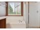 Bathroom showcasing a soaking tub, walk-in shower, and modern fixtures at 4016 S Rome St, Aurora, CO 80018