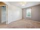Bedroom with carpet, ceiling fan and a window with natural light at 4016 S Rome St, Aurora, CO 80018