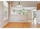 Open-concept dining room featuring hardwood floors and backyard views at 4016 S Rome St, Aurora, CO 80018