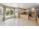 Bright kitchen featuring stainless steel appliances, wooden cabinets, and a sliding glass door to the deck at 4016 S Rome St, Aurora, CO 80018