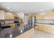 Kitchen showcasing stainless steel appliances, gray countertops, and light wood cabinets at 4016 S Rome St, Aurora, CO 80018