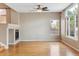 Light-filled living room featuring hardwood floors, large windows, and a fireplace at 4016 S Rome St, Aurora, CO 80018