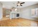 Spacious living room featuring a fireplace, hardwood floors, and backyard views at 4016 S Rome St, Aurora, CO 80018