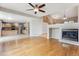 Open concept space with hardwood floors, fireplace, and view of the kitchen at 4016 S Rome St, Aurora, CO 80018