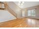 Light-filled living room features hardwood floors, staircase, and vaulted ceiling at 4016 S Rome St, Aurora, CO 80018