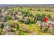 Scenic aerial view of a residential neighborhood with well-maintained homes and mature trees in a sprawling green landscape at 6505 S Garfield Ct, Centennial, CO 80121