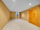 Finished basement area with neutral walls, plush carpet, and a window for natural light at 6505 S Garfield Ct, Centennial, CO 80121