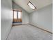 Cozy bedroom with window seat and skylight, neutral walls, and plush carpet at 6505 S Garfield Ct, Centennial, CO 80121