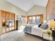Bright bedroom with vaulted ceiling, brick accent wall, and cozy window seat with view at 6505 S Garfield Ct, Centennial, CO 80121