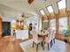 Open floor plan featuring a dining area and kitchen with natural light from skylights at 6505 S Garfield Ct, Centennial, CO 80121