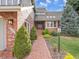 Charming brick home featuring mature landscaping, a brick walkway, and a covered front entrance at 6505 S Garfield Ct, Centennial, CO 80121