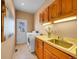 Functional laundry room with ample cabinet space, a sink, and a washer and dryer for convenience at 6505 S Garfield Ct, Centennial, CO 80121